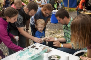 A GRoW Home member interacting with members of the public at Fall Festival at Reinstein Woods